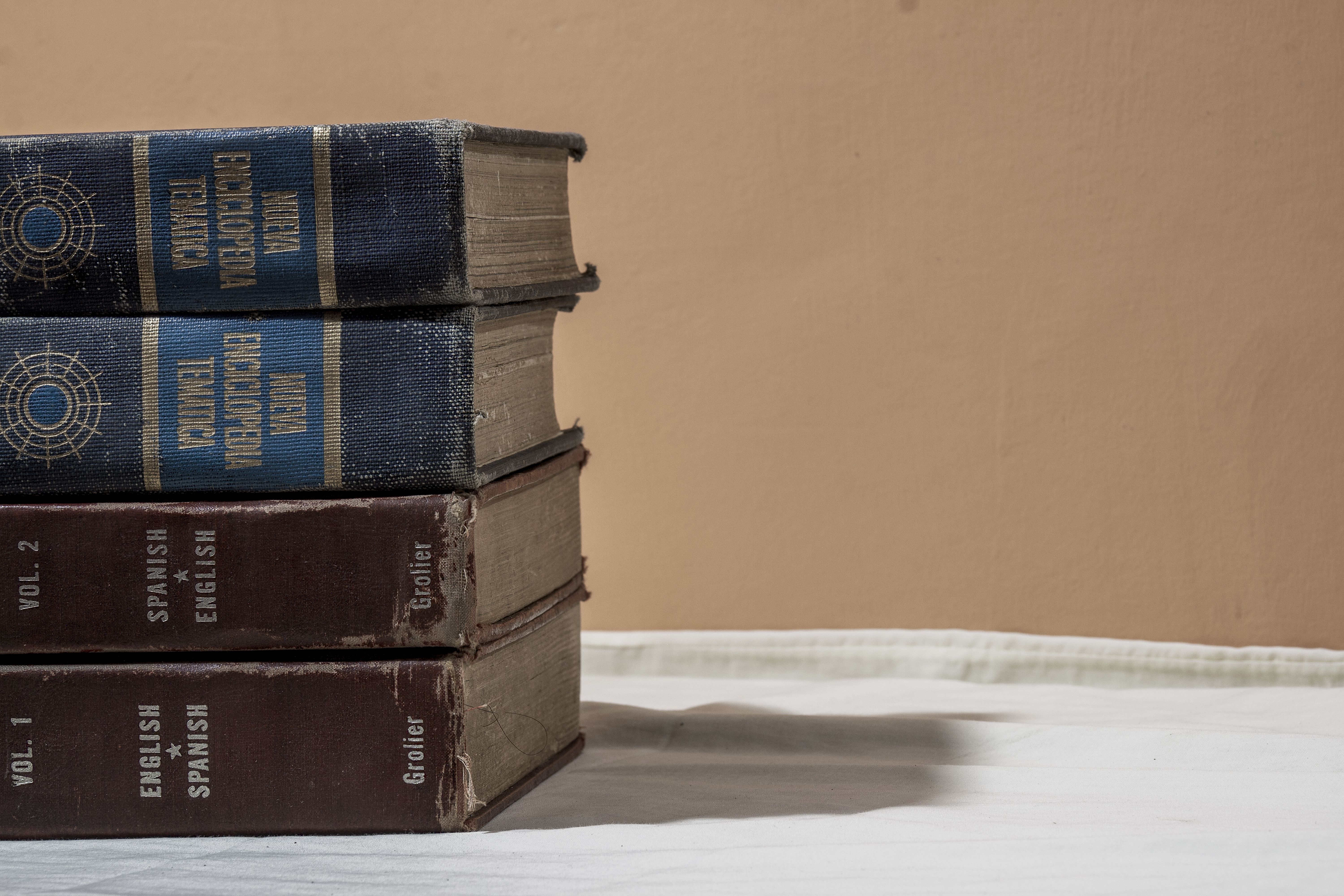A stack of bilingual English and Spanish dictionaries