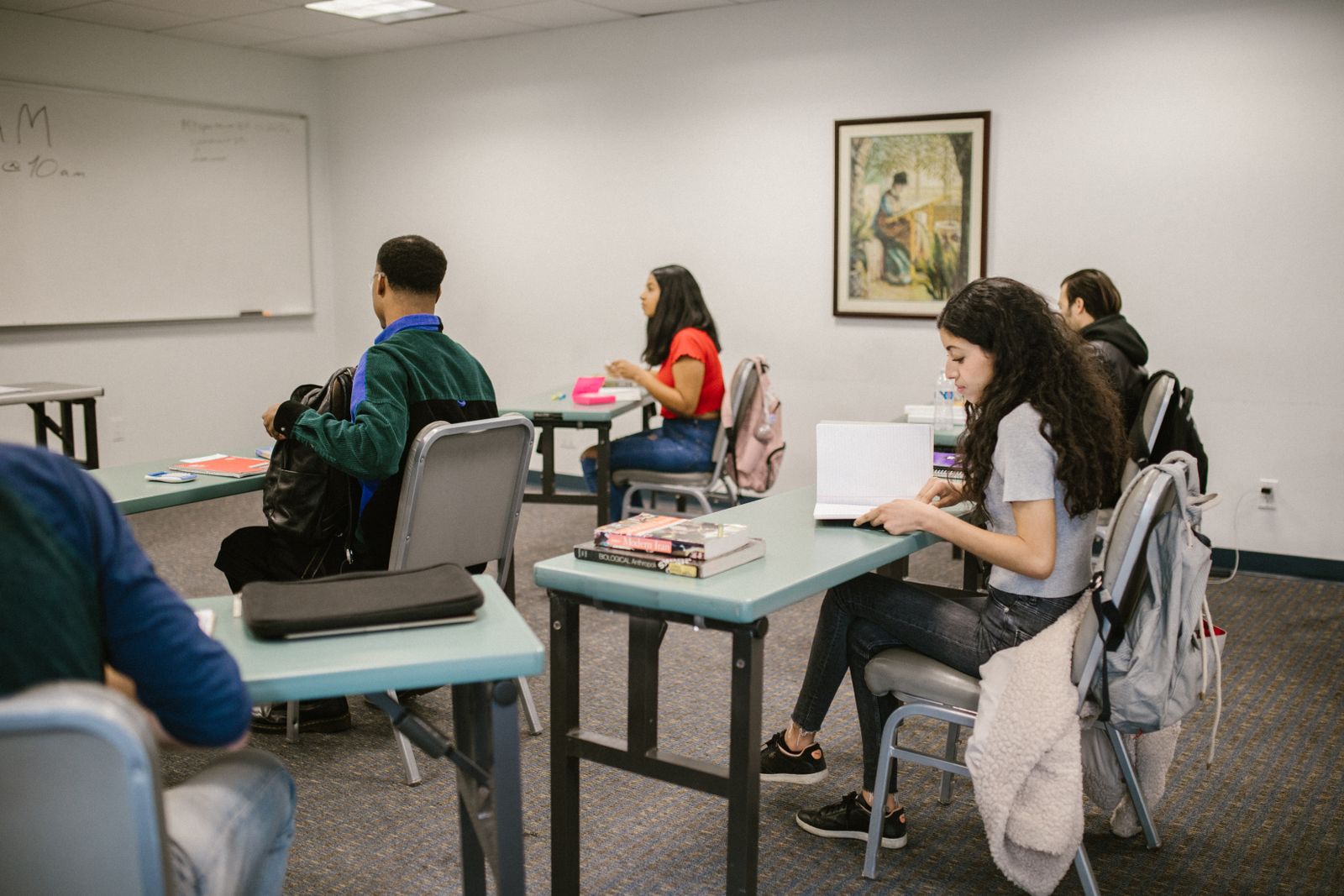 College students studying with books in a classroom