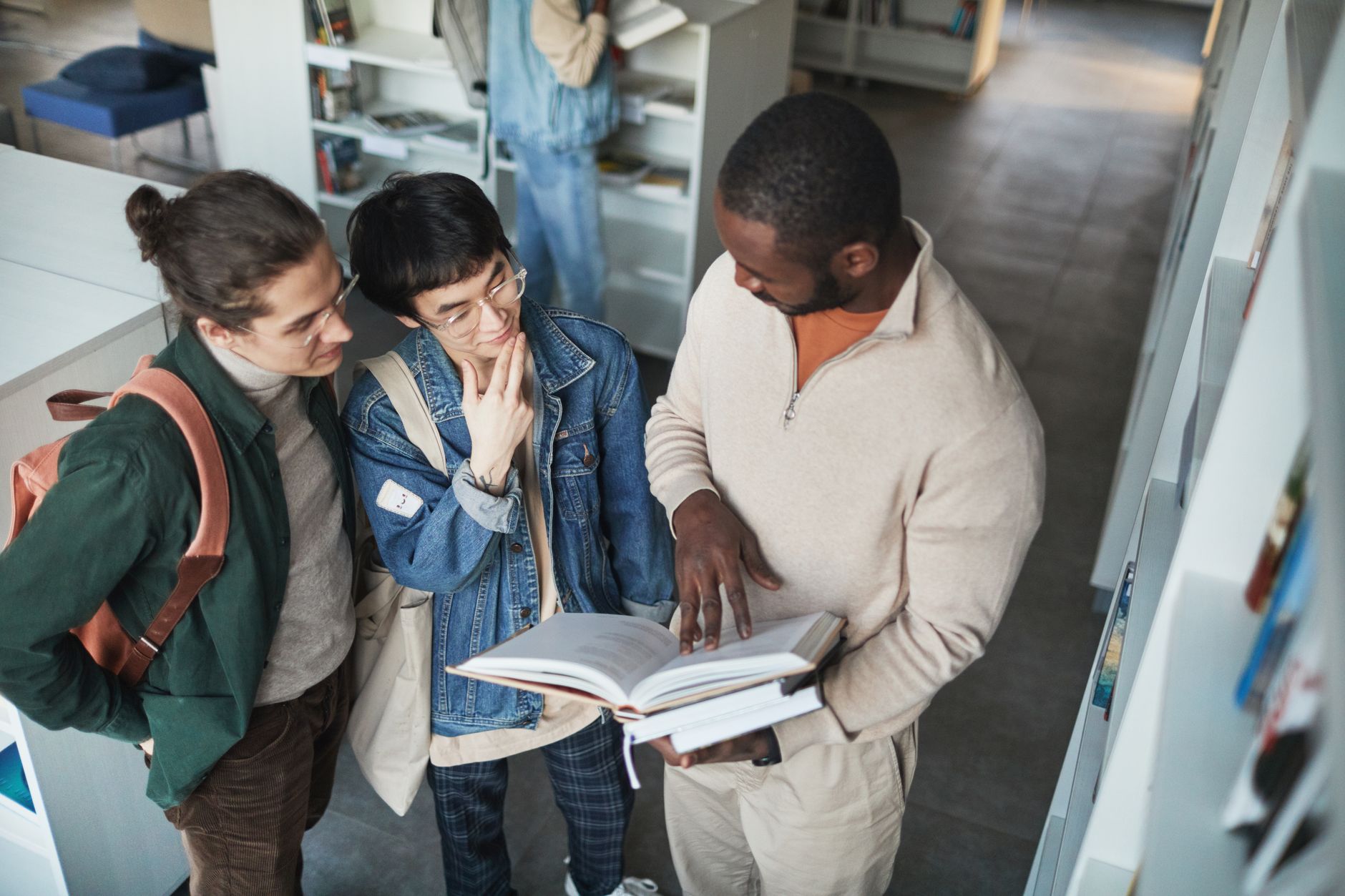 students in a library looking at a book